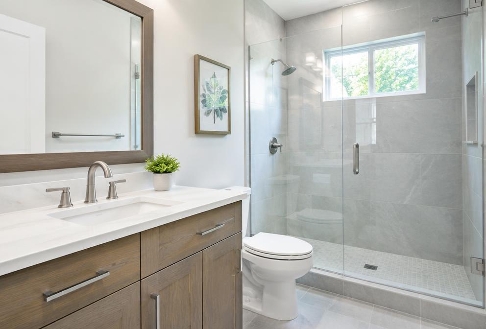 Example photo of a remodeled bathroom with new vanity and shower